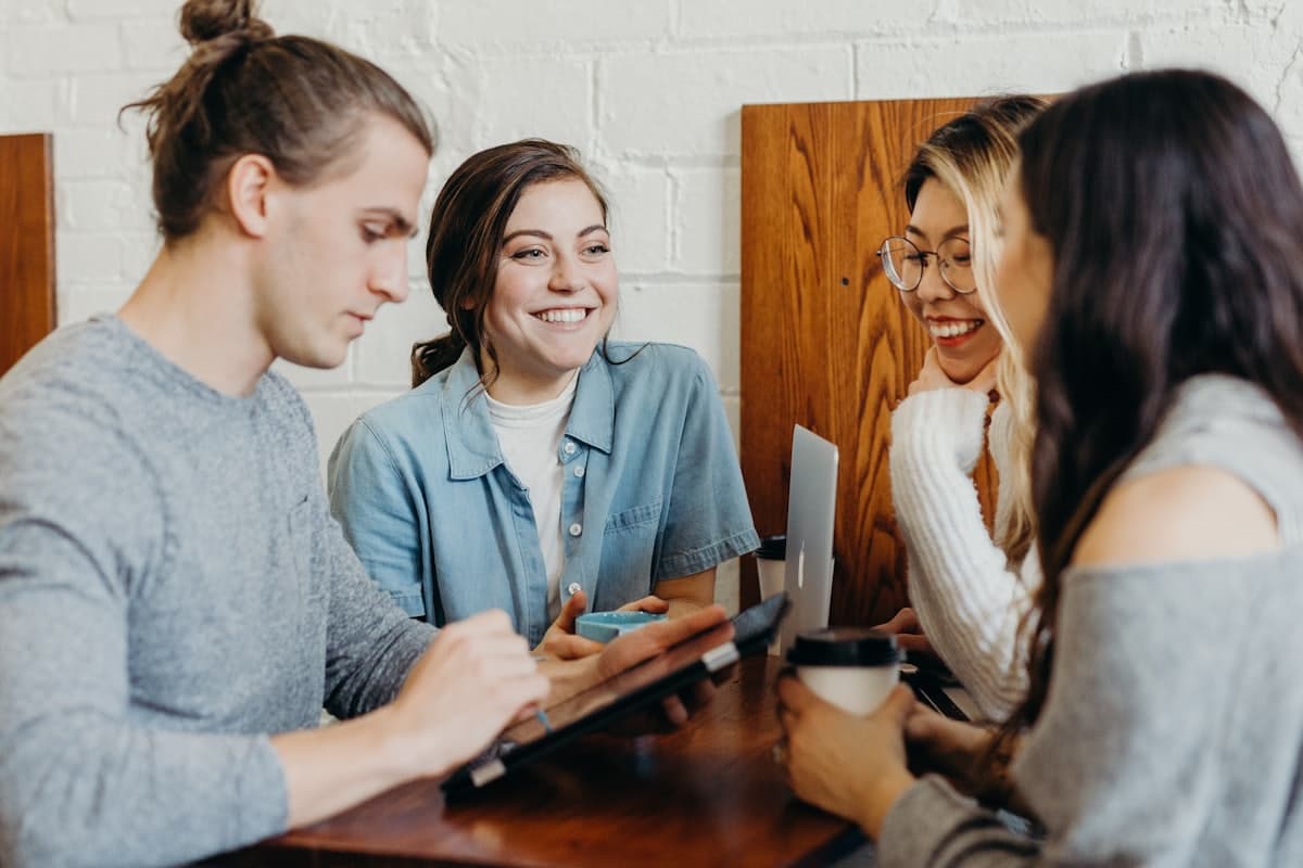 Team members enjoying a discussion over coffee