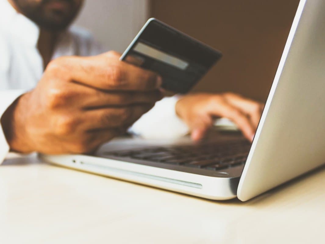 A customer entering card details to check out from an online store on a laptop