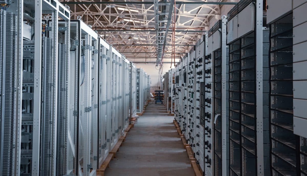 A bright data centre aisle lined with server racks